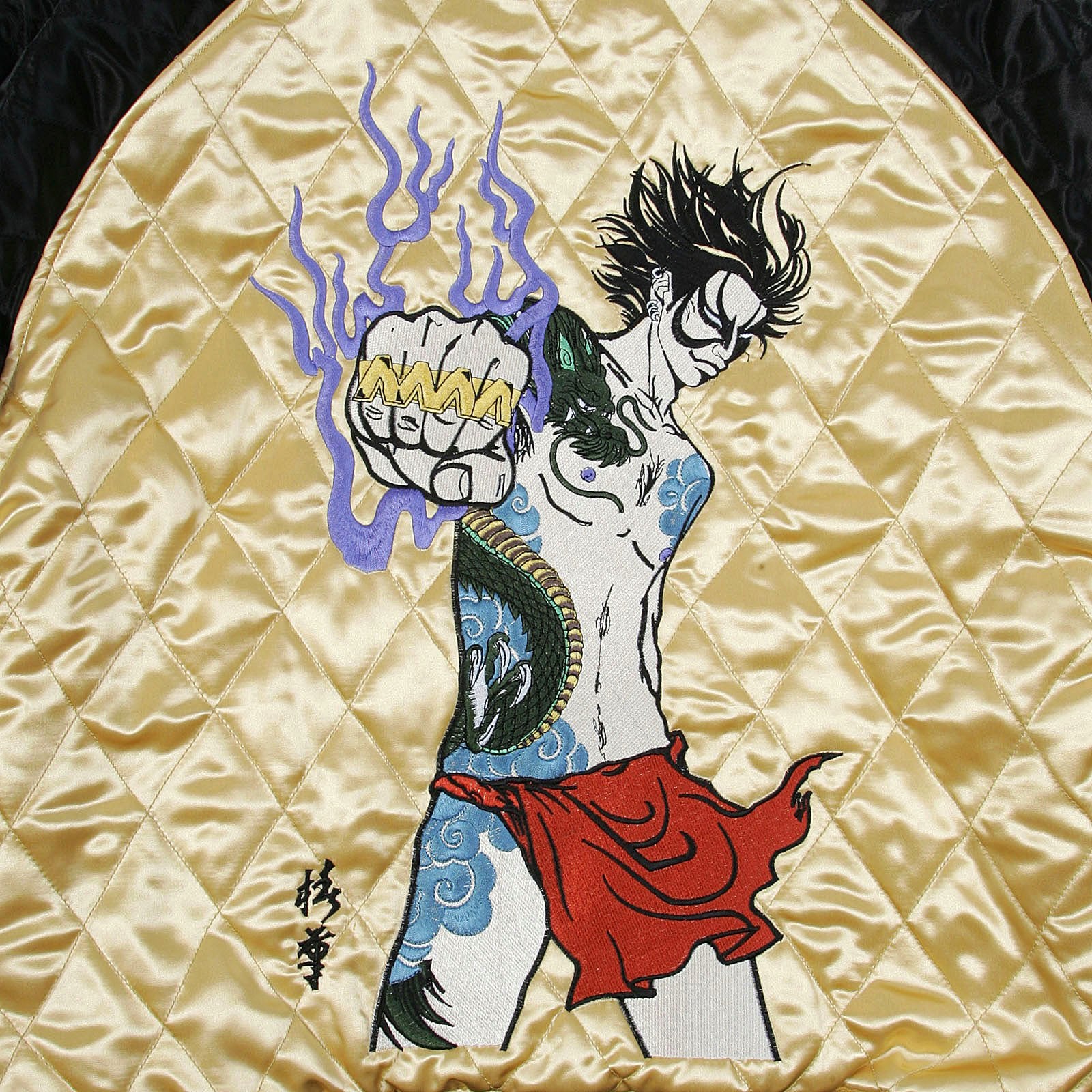 YOROPIKO X RMC JEANS REVERSIBLE EMBROIDERED 4A HERO SOUVENIR JACKET WITH QUILTED BLACK BODY AND GOLD SLEEVES YORO2140A