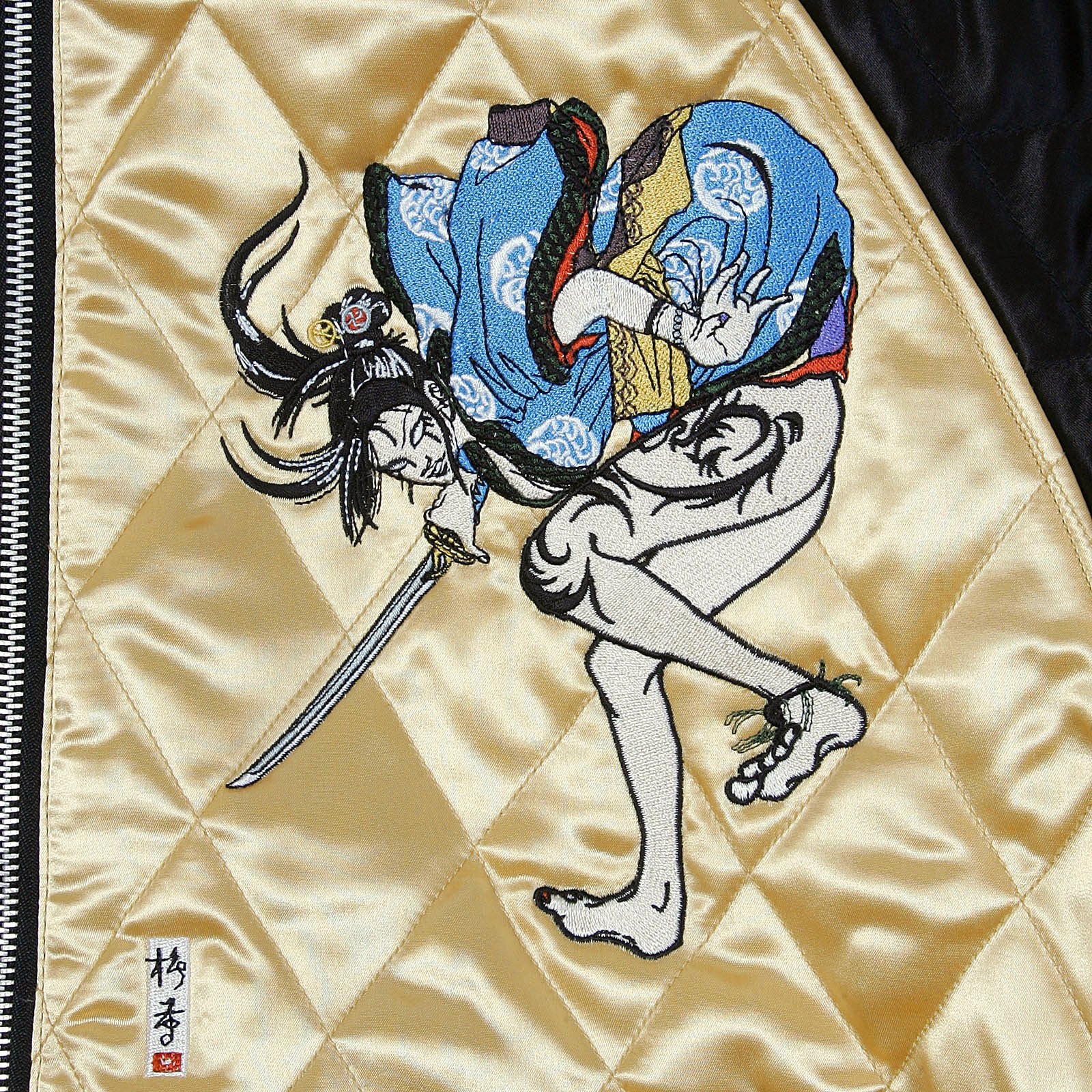 YOROPIKO X RMC JEANS REVERSIBLE EMBROIDERED 4A HERO SOUVENIR JACKET WITH QUILTED BLACK BODY AND GOLD SLEEVES YORO2140A